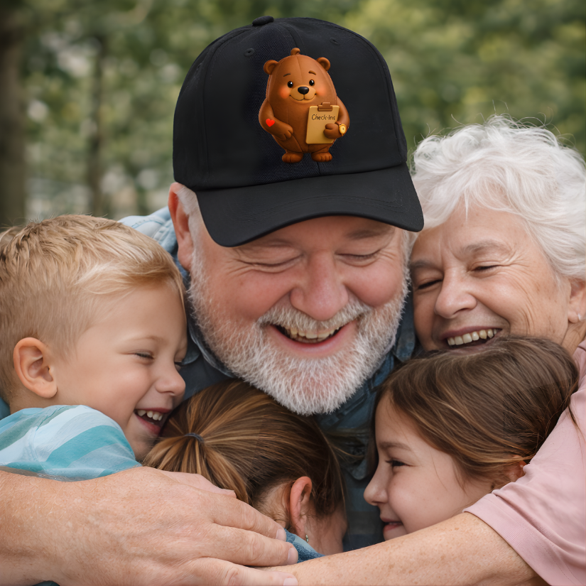 Grandparents hugging their grandchildren outdoors with a black dad hat featuring a cacao teddy bear design.