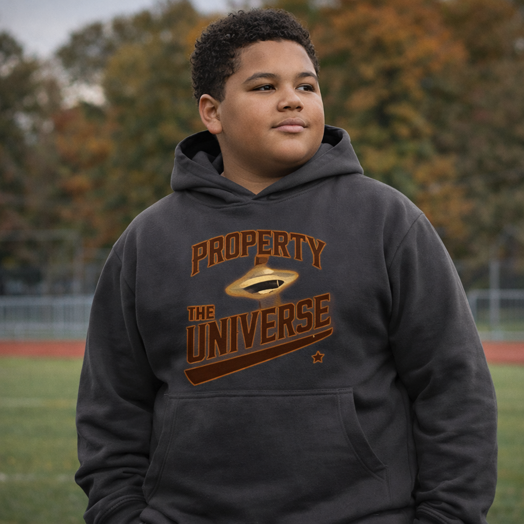 Person wearing a hoodie with 'Property of the Universe' text on a grassy field.